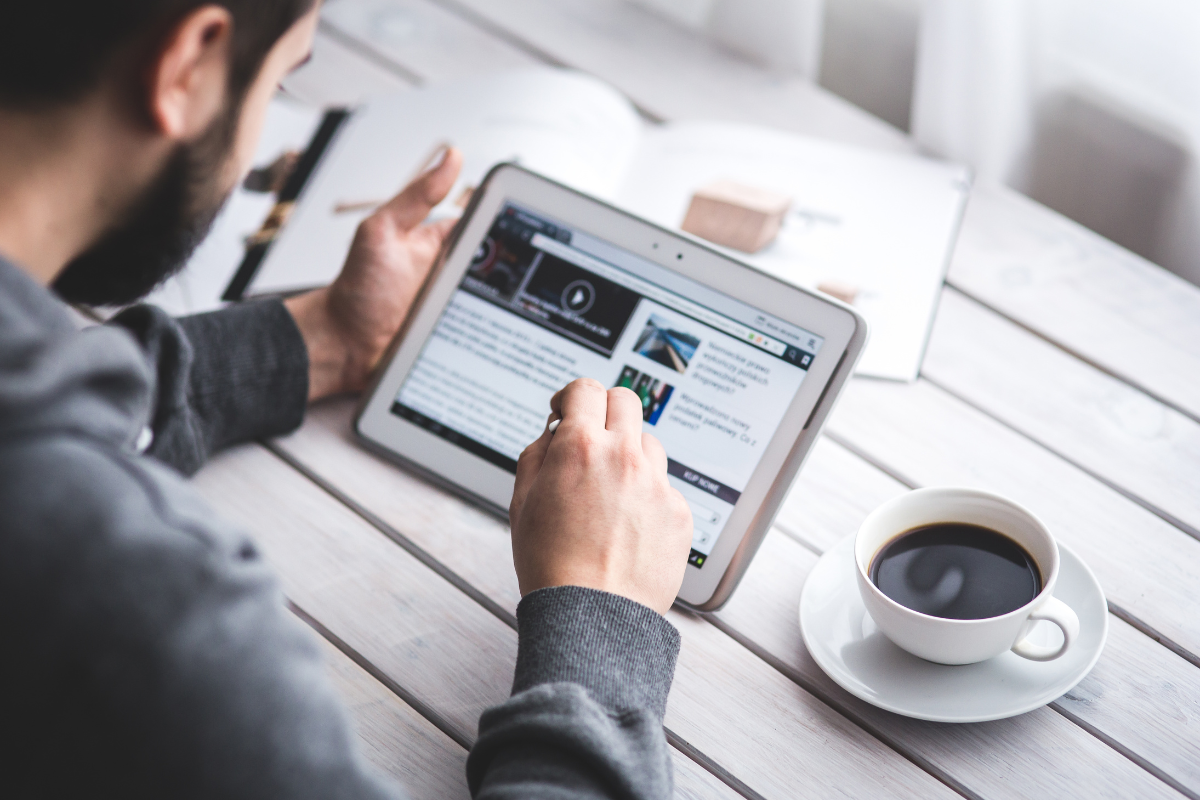 Employee reading employee newsletter articles that benefit organization